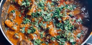 An illustrative dish topped with green herbs.